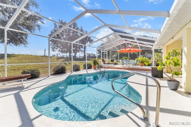 view of swimming pool with a patio area and glass enclosure