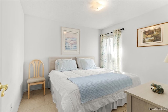 bedroom with light tile patterned floors