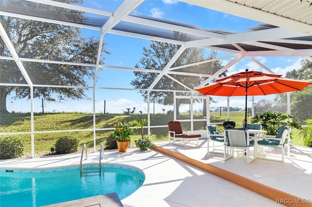 view of pool with a patio and a lanai