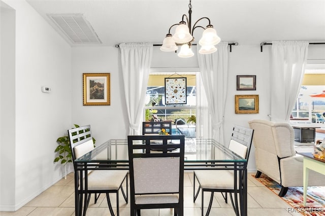 dining room featuring light tile patterned floors and a chandelier