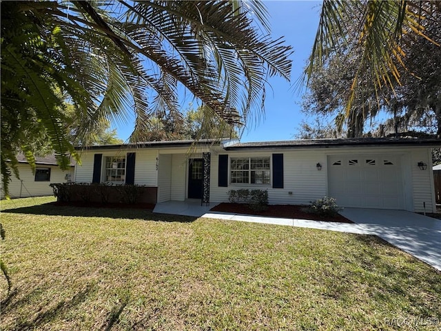 ranch-style house with an attached garage, driveway, and a front lawn