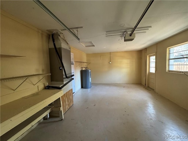 garage featuring a garage door opener and water heater