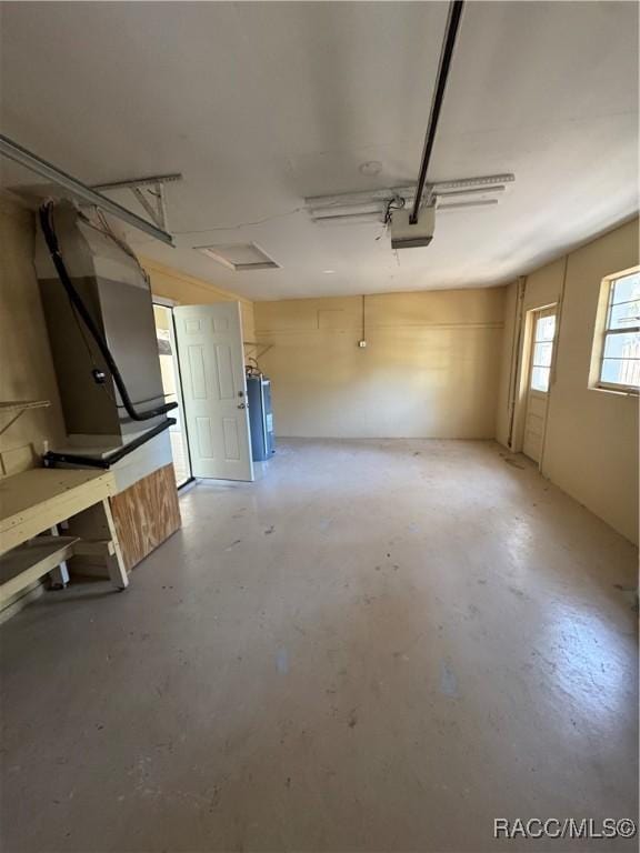 garage featuring a garage door opener and water heater