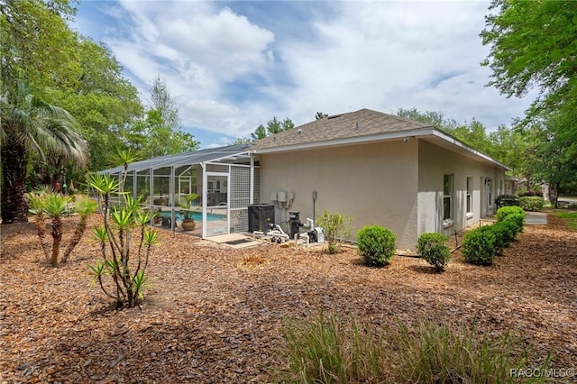 4198 N Longvalley Rd, Hernando, FL 34442 - back of property with an outdoor pool, stucco siding, and glass enclosure