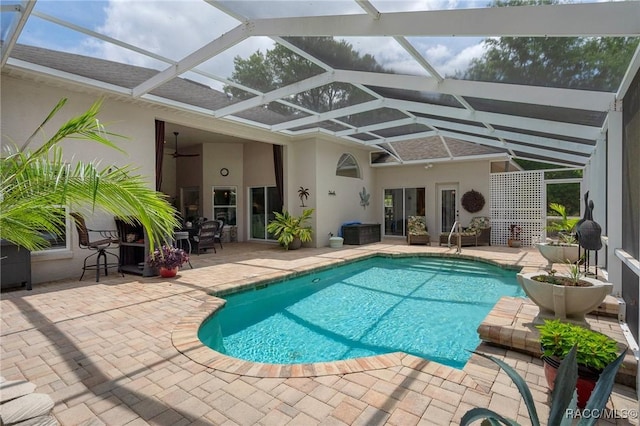4198 N Longvalley Rd, Hernando, FL 34442 - outdoor pool with a ceiling fan, a patio area, and glass enclosure