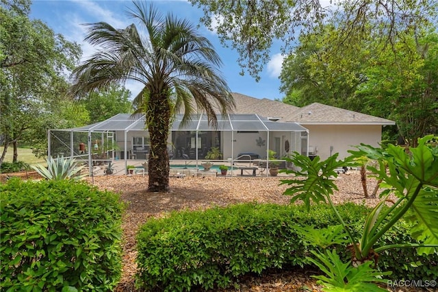 4198 N Longvalley Rd, Hernando, FL 34442 - back of house with glass enclosure, stucco siding, and an outdoor pool