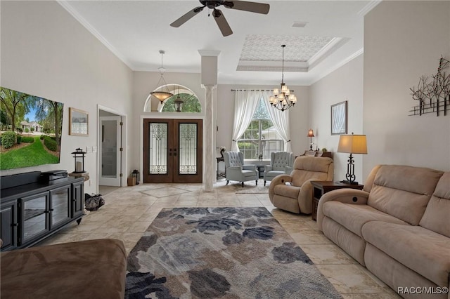 4198 N Longvalley Rd, Hernando, FL 34442 - living area with crown molding, a tray ceiling, light tile patterned flooring, french doors, and ceiling fan with notable chandelier