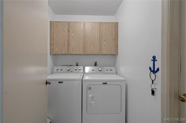 washroom with cabinet space and independent washer and dryer