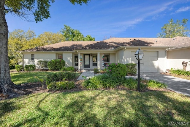 ranch-style house featuring stucco siding, driveway, a front yard, and an attached garage