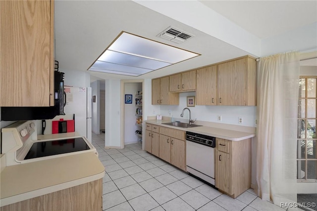 kitchen featuring visible vents, light brown cabinets, a sink, electric range oven, and white dishwasher