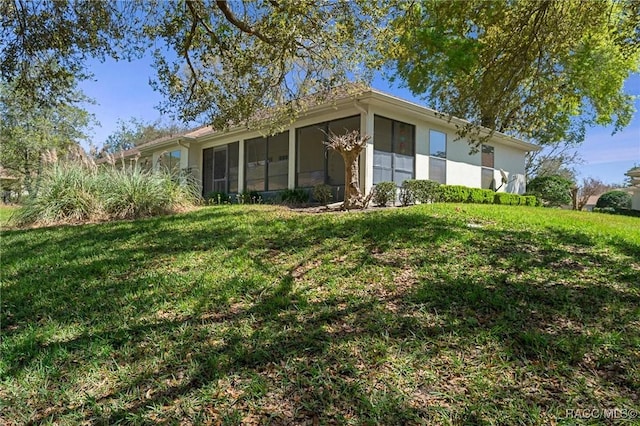 view of front facade with a front lawn and a sunroom