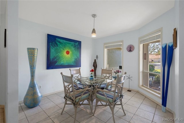 dining room featuring light tile patterned floors and baseboards