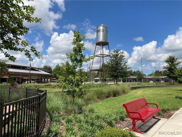 surrounding community featuring a yard and fence