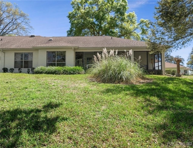 view of front of house featuring a front lawn, a garage, and stucco siding