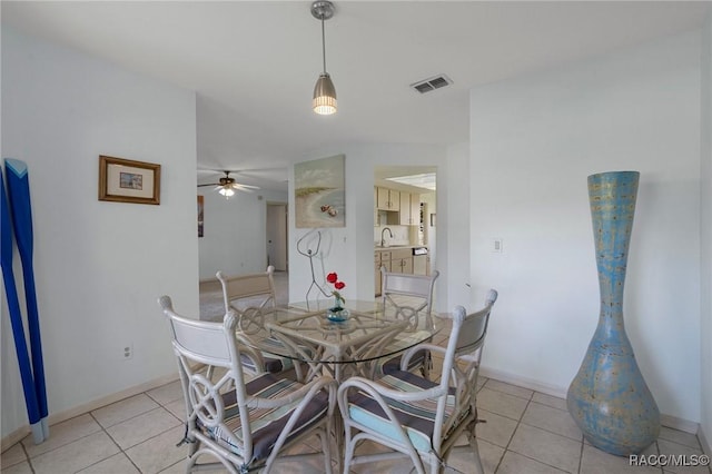 dining area with light tile patterned floors, visible vents, and baseboards