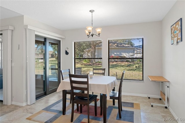 dining area with light tile patterned floors and a chandelier