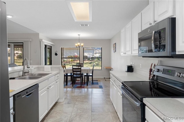 kitchen featuring stainless steel appliances, hanging light fixtures, sink, and white cabinets