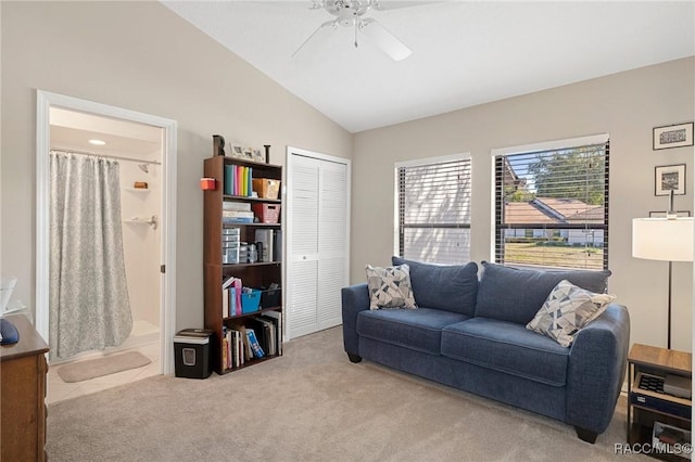 carpeted living room featuring vaulted ceiling and ceiling fan