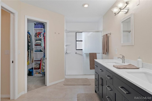 bathroom featuring vanity, tile patterned floors, and a shower with shower door