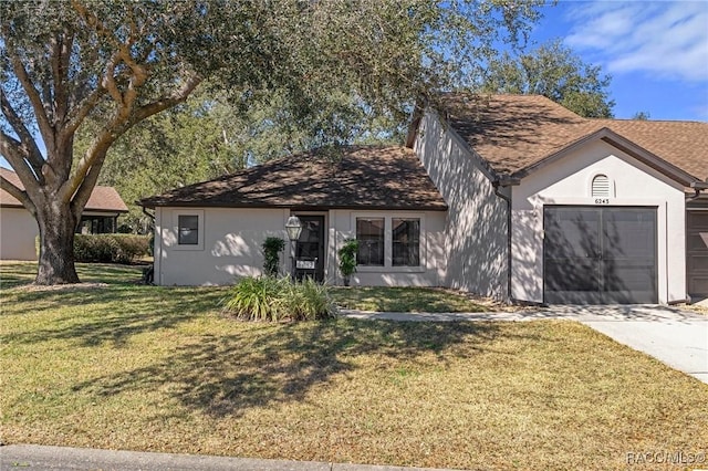 view of front of house with a garage and a front lawn