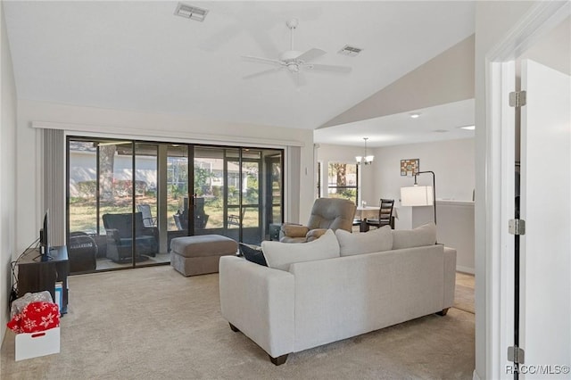 carpeted living room featuring lofted ceiling and ceiling fan with notable chandelier