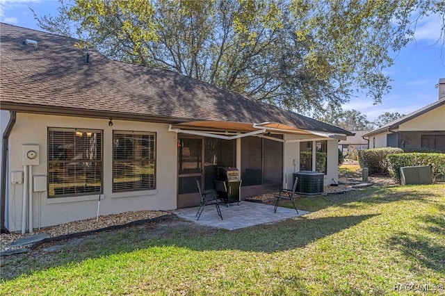 rear view of property with a patio, a yard, and central air condition unit