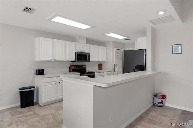 kitchen featuring white cabinets, kitchen peninsula, sink, and black appliances