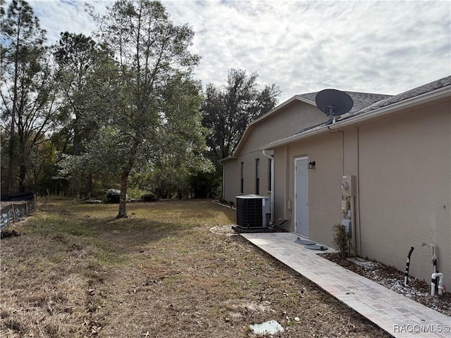 view of yard featuring central air condition unit