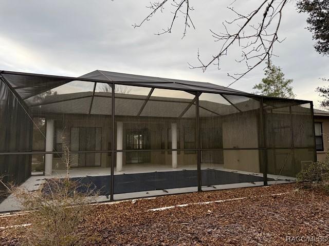 rear view of house featuring a lanai and a patio