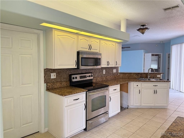 kitchen featuring appliances with stainless steel finishes, sink, white cabinets, and kitchen peninsula