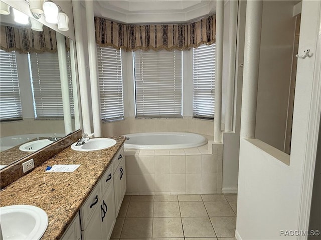 bathroom featuring vanity, tile patterned floors, and tiled bath