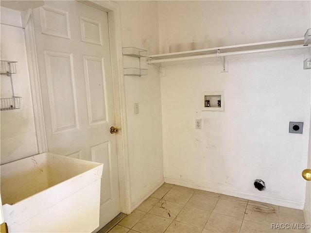 washroom featuring hookup for a washing machine, light tile patterned flooring, and hookup for an electric dryer