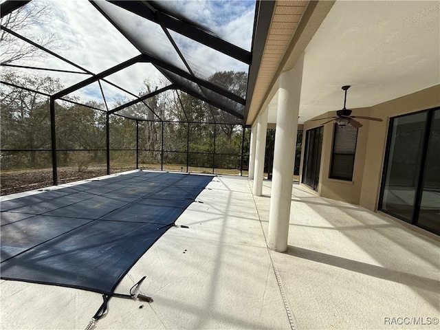 view of swimming pool with a lanai, a patio, and ceiling fan