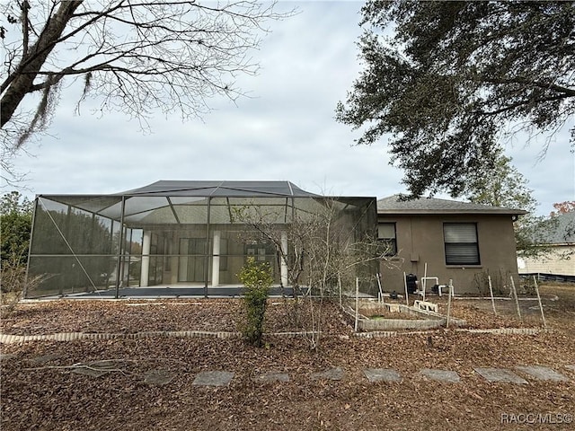 rear view of property featuring a lanai