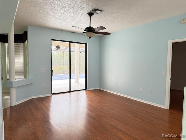 spare room with hardwood / wood-style flooring, a textured ceiling, and ceiling fan