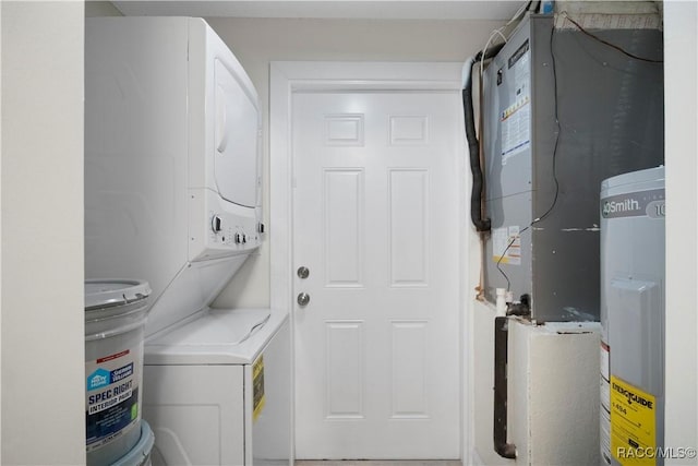 laundry area with laundry area, heating unit, stacked washing maching and dryer, and water heater