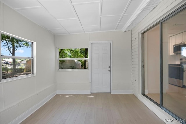 interior space with baseboards and light wood-style flooring