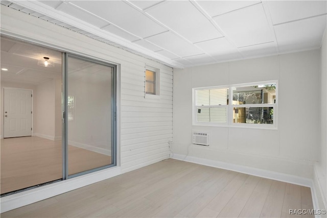 spare room featuring light wood-style floors and baseboards