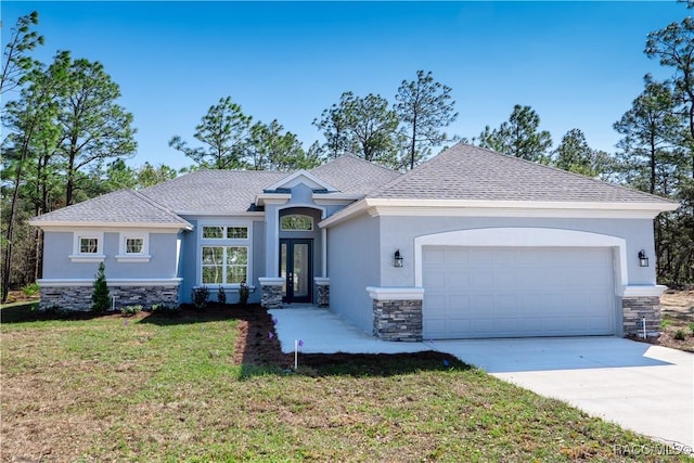 view of front of home featuring stone siding, stucco siding, concrete driveway, and a garage