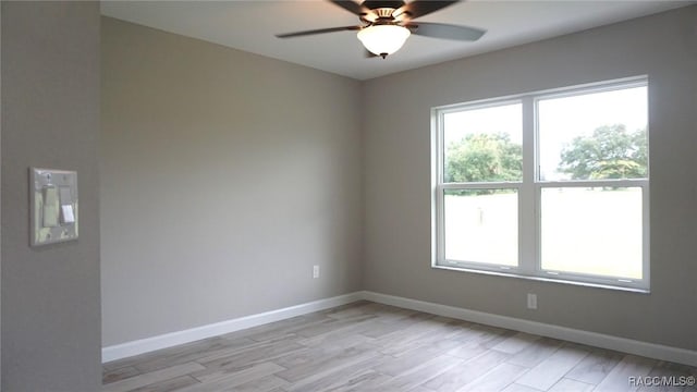 empty room with light hardwood / wood-style floors and ceiling fan