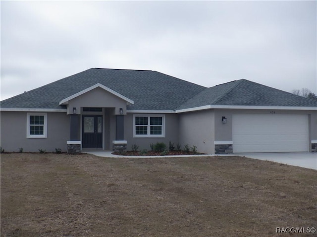 ranch-style home featuring a garage and a front yard