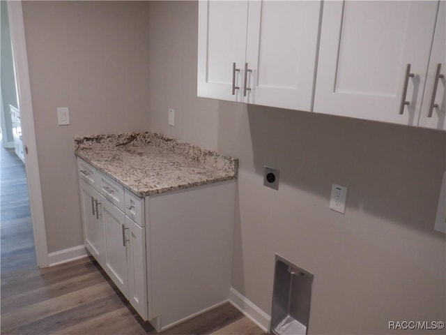 clothes washing area with cabinets, wood-type flooring, and hookup for an electric dryer