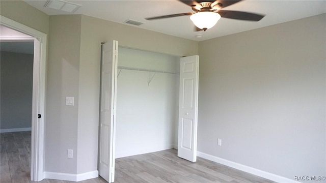 unfurnished bedroom with light hardwood / wood-style floors, a closet, and ceiling fan