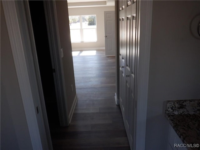 hallway with dark hardwood / wood-style floors