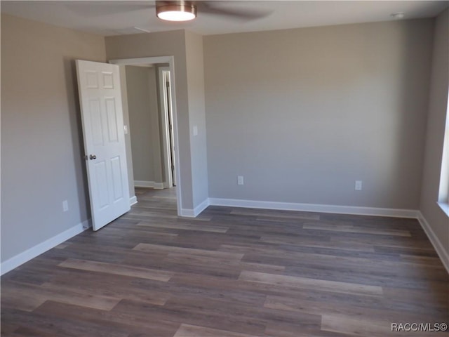 unfurnished room featuring ceiling fan and dark hardwood / wood-style floors