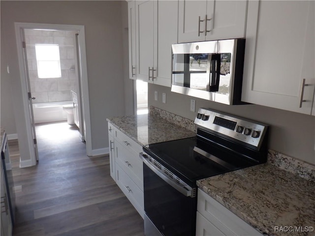 kitchen featuring stainless steel appliances, dark hardwood / wood-style flooring, light stone countertops, and white cabinets