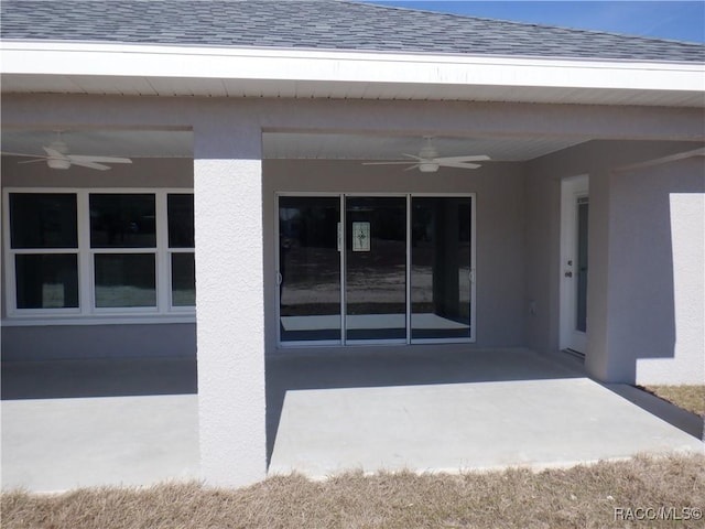 entrance to property featuring a patio and ceiling fan