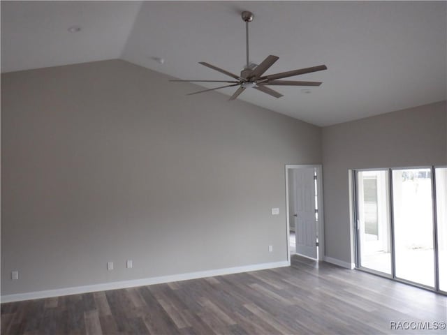 spare room with vaulted ceiling, wood-type flooring, and ceiling fan