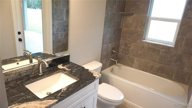 full bathroom featuring vanity, toilet, a wealth of natural light, and tiled shower / bath combo