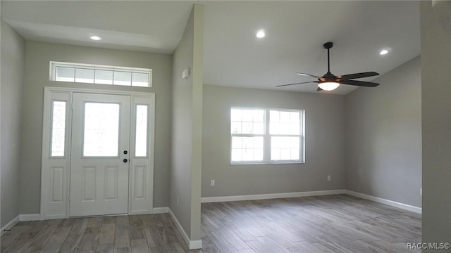 foyer entrance with ceiling fan and light wood-type flooring